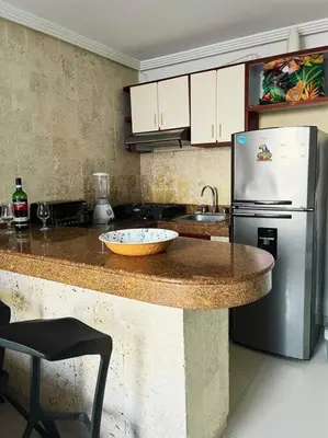 a kitchen with a counter top with a refrigerator at Beach retreat in El Laguito in Cartagena de Indias