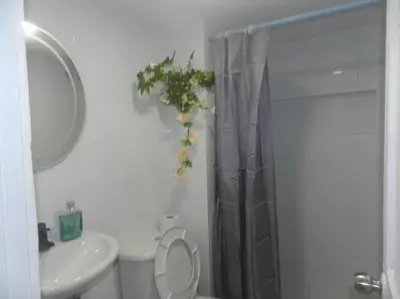 a bathroom with a toilet and a sink and a shower at la Ola de la Vida con AA WIFI in Cartagena de Indias