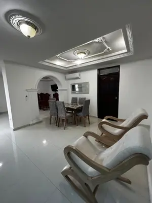 a living room with chairs and a table in it at Antares Apartment in Cartagena de Indias