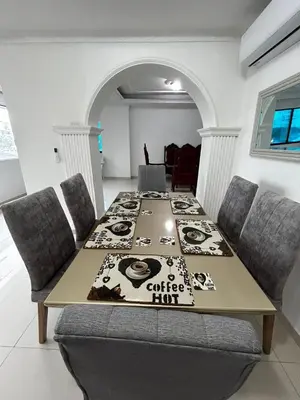 a dining room with a table with a coffee hive on it at Antares Apartment in Cartagena de Indias