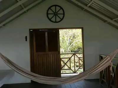 a hammock in a room with a door and a window at La Boquilla, Cartagena, Hospedaje, Turismocolombia-fit in Cartagena de Indias