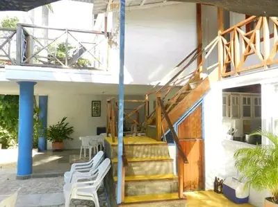 a staircase in a building with white chairs at La Boquilla, Cartagena, Hospedaje, Turismocolombia-fit in Cartagena de Indias