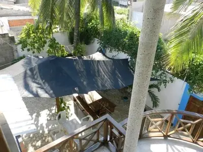 a balcony with a table and chairs and a palm tree at La Boquilla, Cartagena, Hospedaje, Turismocolombia-fit in Cartagena de Indias