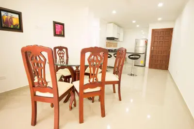 a dining room with a table and four chairs at Caribbean Summer - Livin Colombia in Cartagena de Indias