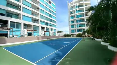 a tennis court in front of a building at Sensacional! Apartamento Cartagena Morros SeaWay in Cartagena de Indias
