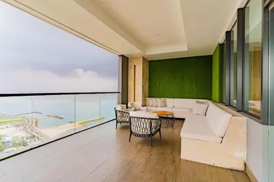 a living room with a view of the ocean at U-GO Vistas al Mar desde Murano Centro: Piscina, Jacuzzi y Más in Cartagena de Indias