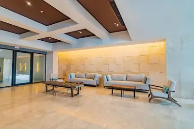 a lobby with couches and tables in a building at U-GO Vistas al Mar desde Murano Centro: Piscina, Jacuzzi y Más in Cartagena de Indias