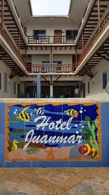 a banner on a wall in front of a building at Hotel Juanmar in Juan de Acosta