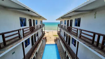 a view of the ocean from the balcony of a building at Hotel Juanmar in Juan de Acosta