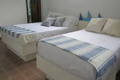 two beds sitting next to each other in a room at Casa Amin Tolu in San Silvestre