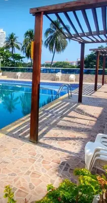a swimming pool with a pavilion and chairs next to it at Apartamento bonito en Cartagena ,el laguito bocagrande con vista al mar in Cartagena de Indias