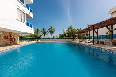 a large blue swimming pool next to a building at Apartamento bonito en Cartagena ,el laguito bocagrande con vista al mar in Cartagena de Indias