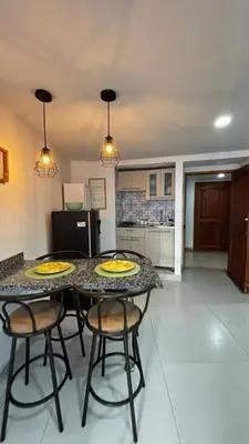a kitchen with a table with two yellow plates on it at Apartamento bonito en Cartagena ,el laguito bocagrande con vista al mar in Cartagena de Indias