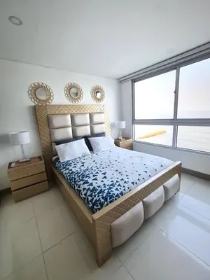 a bedroom with a bed and a large window at Beachfront Luxurious Apartment, Palmetto Beach in Cartagena de Indias
