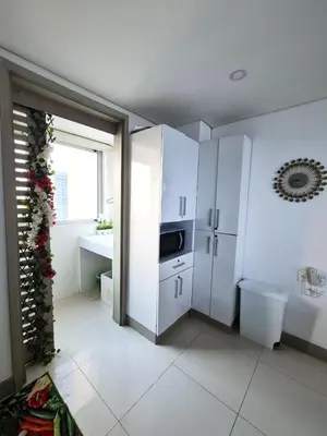 a white kitchen with a sink and a refrigerator at Beachfront Luxurious Apartment, Palmetto Beach in Cartagena de Indias