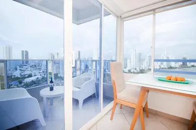 a dining room with a view of the city at Riviera Sunrise Beach - Frente al mar y vista panorámica a toda la ciudad in Cartagena de Indias