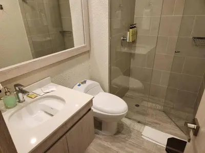 a bathroom with a toilet and a sink and a shower at Dominique luxury 1410 Jacuzzi Privado in Cartagena de Indias