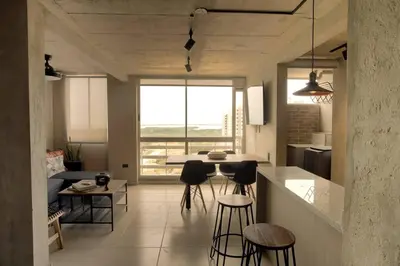 a kitchen with chairs and a table in a room at Encantador apartamento de diseño con hermosas vistas en Ciudad Mallorquín in Puerto Colombia