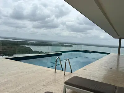 a swimming pool with a view of the ocean at Cartagena SUNNO BEACH in Cartagena de Indias