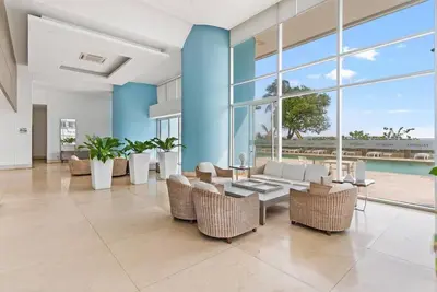 a living room with chairs and a table and windows at Palmetto Sunset 3204 in Cartagena de Indias