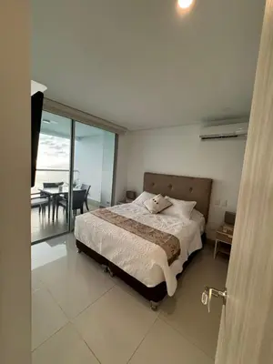 a bedroom with a bed and a view of the ocean at Palmetto Sunset 3204 in Cartagena de Indias