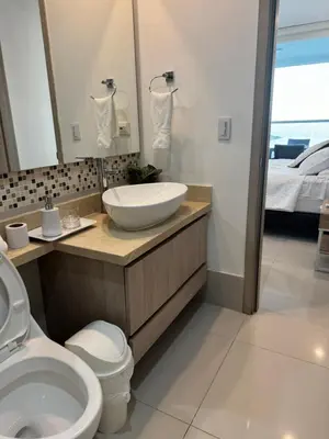a bathroom with a sink and a toilet and a bed at Palmetto Sunset 3204 in Cartagena de Indias