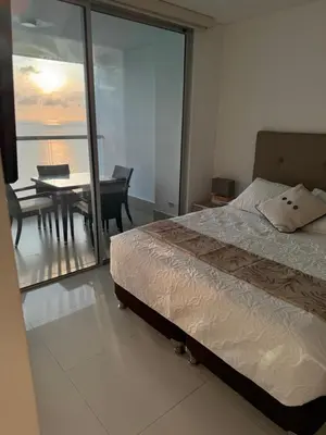 a bedroom with a bed and a view of the ocean at Palmetto Sunset 3204 in Cartagena de Indias