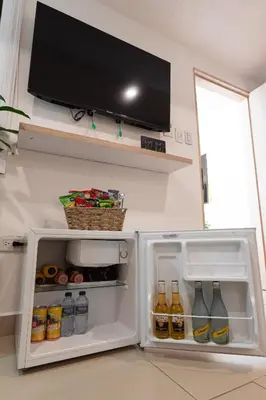 an open refrigerator with a tv on the wall at Casa Mishka Hotel Boutique Habitación #105 Nuevo Cartagena in Cartagena de Indias