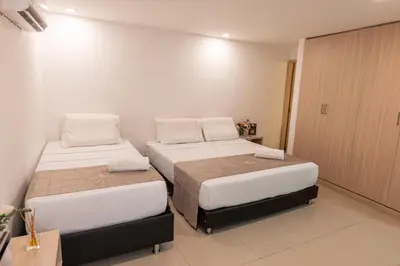 two beds in a hotel room with a room at Casa Mishka Hotel Boutique Habitación #105 Nuevo Cartagena in Cartagena de Indias
