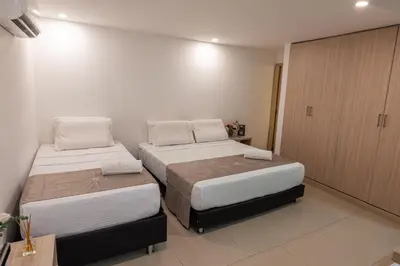 two beds in a small room with at Casa Mishka Hotel Boutique Habitación #105 Nuevo Cartagena in Cartagena de Indias