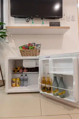 an open refrigerator filled with drinks and drinks at Casa Mishka Hotel Boutique Habitación #105 Nuevo Cartagena in Cartagena de Indias