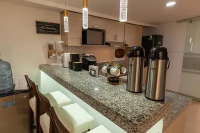a kitchen with a counter with two coffee machines on it at Casa Mishka Hotel Boutique Habitación #104 Nuevo Cartagena in Cartagena de Indias