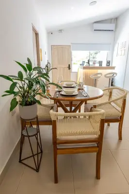 a dining room with a table and chairs and a plant at Casa Mishka Hotel Boutique Habitación #104 Nuevo Cartagena in Cartagena de Indias