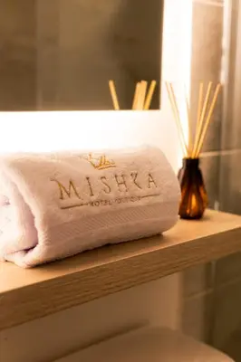 a towel that says maliki sitting on a wooden shelf at Casa Mishka Hotel Boutique Habitación #104 Nuevo Cartagena in Cartagena de Indias