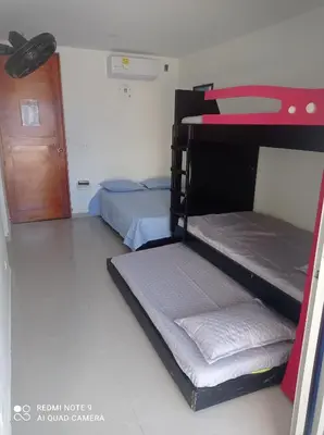 two bunk beds in a room with a door at Cabaña campestre Villa Liliana in Juan de Acosta