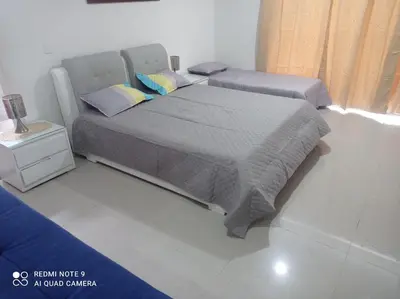a bedroom with a bed and a night stand at Cabaña campestre Villa Liliana in Juan de Acosta