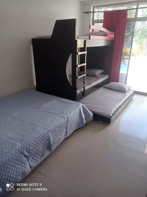 a bedroom with two bunk beds and a ladder at Cabaña campestre Villa Liliana in Juan de Acosta