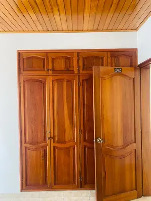 an empty room with wooden doors and a ceiling at Hostel Cerca al Centro Histórico in Cartagena de Indias