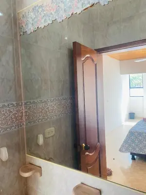 a bathroom with a shower with a mirror at Hostel Cerca al Centro Histórico in Cartagena de Indias