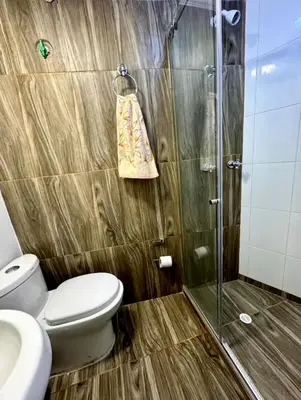 a bathroom with a toilet and a glass shower at APARTAMENTO NUEVO Y ACOGEDOr in Cartagena de Indias