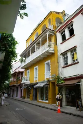 a yellow building on the side of a street at Loft con terraza y jacuzzi en el centro historico in Cartagena de Indias