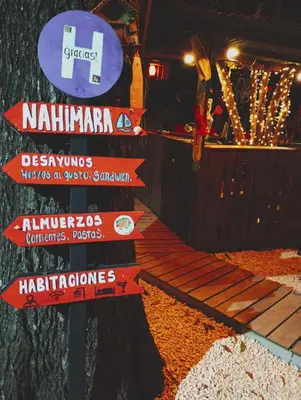 a street sign with signs in front of a ride at Nahimara Champeta Hostel in Cartagena de Indias