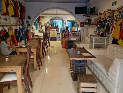 a store with tables and chairs in a room at Nahimara Champeta Hostel in Cartagena de Indias