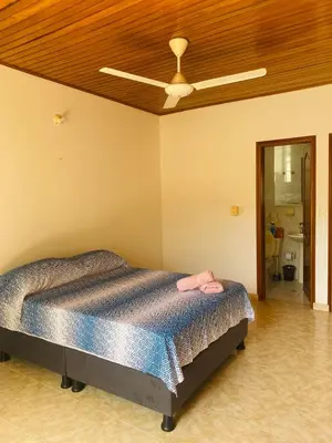 a bedroom with a bed with a ceiling fan at Paraiso Pie de la Popa in Cartagena de Indias