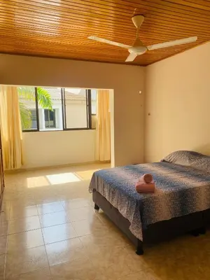 a bedroom with a bed and a ceiling fan at Paraiso Pie de la Popa in Cartagena de Indias