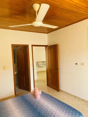 a bedroom with a ceiling fan and a bed at Paraiso Pie de la Popa in Cartagena de Indias