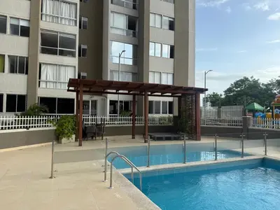 a swimming pool with a pavilion next to a building at Ciudad Mallorquin in Puerto Colombia