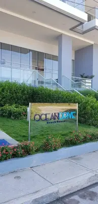 a sign in the grass in front of a building at Apartamento 414 en Ocean Drive - Crespo Cerca al Mar in Cartagena de Indias