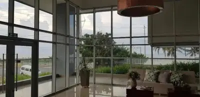 a living room with a couch and a large window at Apartamento 414 en Ocean Drive - Crespo Cerca al Mar in Cartagena de Indias