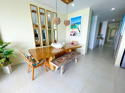 a dining room with a wooden table and chairs at Magico Apartaemento Frente al Mar 4 Habitaciones E92 in Coveñas